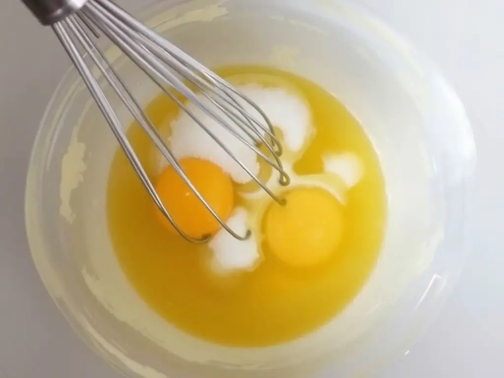 a bowl of whisked eggs and sugar