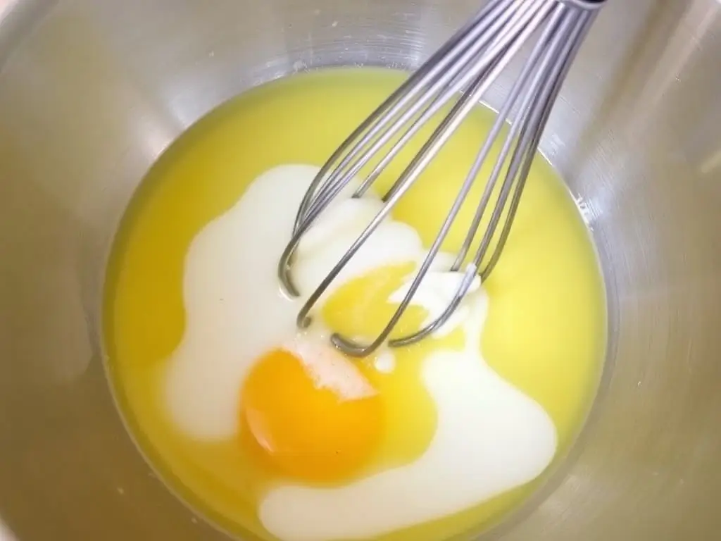 Whisked egg, vinegar, and oil for gluten-free iced buns