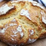 Golden-brown gluten-free Irish soda bread loaf with a rustic crust and scored ‘X’ on top