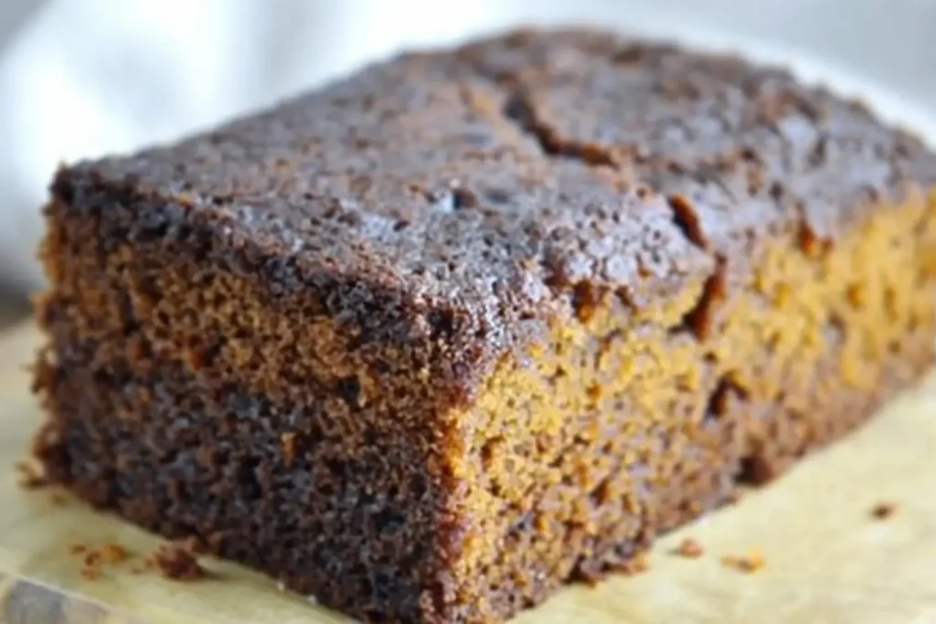 Gluten-free ginger cake cooling in loaf tin after baking