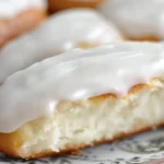 Freshly baked gluten-free iced buns with icing glaze on a kitchen counter